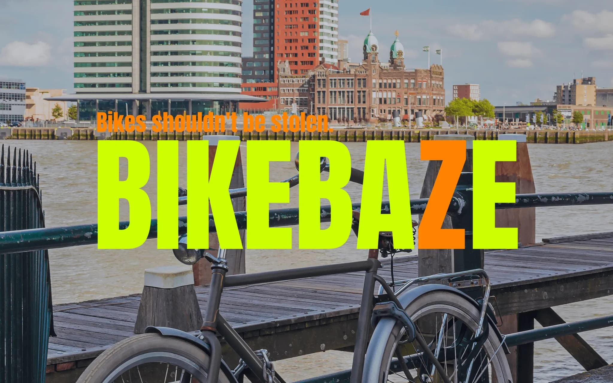 City bike locked to a railing at Rotterdam's Veerhaven with the Kop van Zuid skyline in the background.